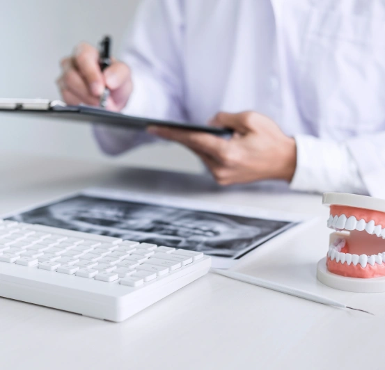 Team member reviewing dental insurance and financing paperwork at South Arlington Smiles in Arlington, TX.
