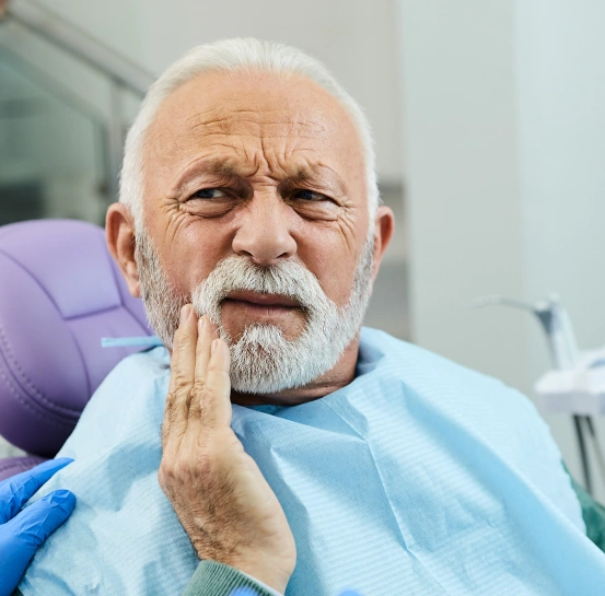 Patient experiencing severe tooth pain at South Arlington Smiles dental office before receiving an emergency tooth extraction in Arlington, TX.